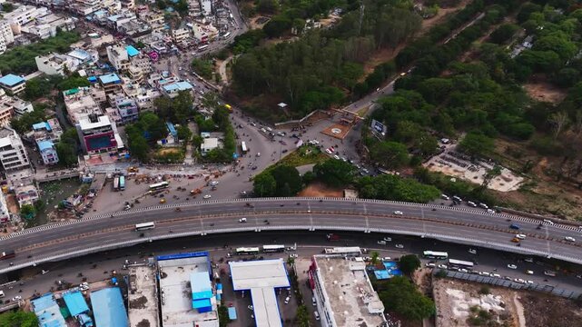 BHEL Entrance with traffic flow, flyover, highway and residential buildings at Lingampally, Chanda nagar, hyderabad, telangana, india. day time, push in shot, bird eye view, drone shot, 4k.