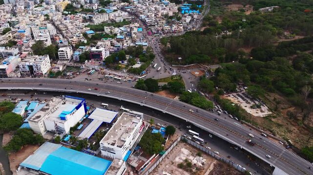 Bhel flyover with BHEL township entrance, vehicles, highway, trees and residential buildings at Lingampally, Chanda nagar, hyderabad, telangana, india. day time, arc shot, drone shot, 4k.