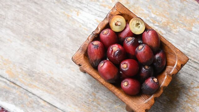Date palm or Phoenix dactylifera fruits on an old wooden background.top view.