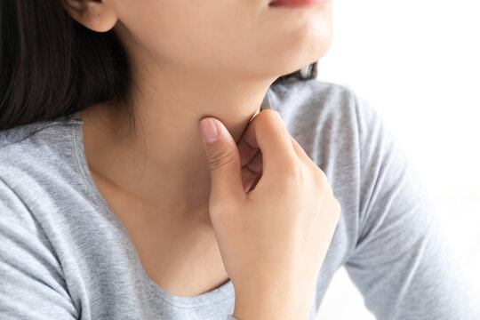 A young Chinese woman with a sore throat in the bedroom