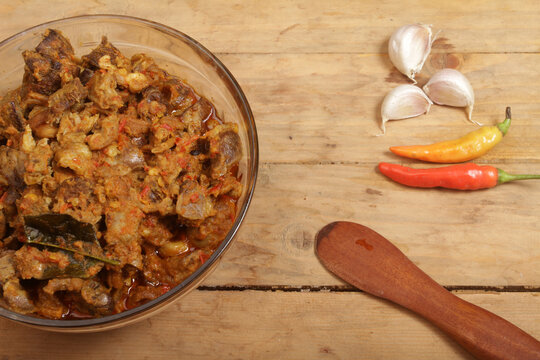 bowl of spicy sambal goreng ati on wooden table