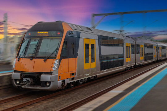 Passenger Train going through Lewisham Train Station at Sunset a suburban Sydney train Station in Sydney NSW Australia