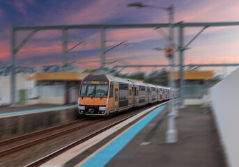 Obraz premium Passenger Train going through Lewisham Train Station at Sunset a suburban Sydney train Station in Sydney NSW Australia