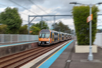 Passenger Train going through Lewisham Train Station at Sunset a suburban Sydney train Station in Sydney NSW Australia © Elias Bitar