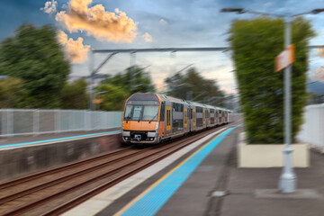 Passenger Train going through Lewisham Train Station at Sunset a suburban Sydney train Station in Sydney NSW Australia © Elias Bitar