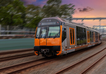 Obraz premium Passenger Train going through Lewisham Train Station at Sunset a suburban Sydney train Station in Sydney NSW Australia
