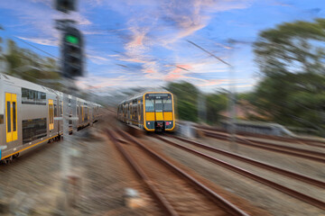 Obraz premium Passenger Train going through Lewisham Train Station at Sunset a suburban Sydney train Station in Sydney NSW Australia