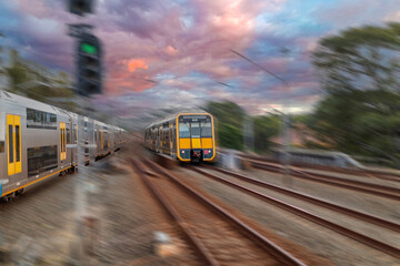 Obraz premium Passenger Train going through Lewisham Train Station at Sunset a suburban Sydney train Station in Sydney NSW Australia