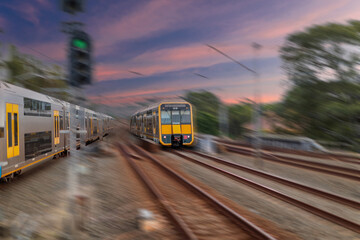 Obraz premium Passenger Train going through Lewisham Train Station at Sunset a suburban Sydney train Station in Sydney NSW Australia