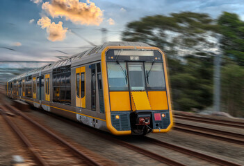 Obraz premium Passenger Train going through Lewisham Train Station at Sunset a suburban Sydney train Station in Sydney NSW Australia