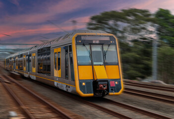 Fototapeta premium Passenger Train going through Lewisham Train Station at Sunset a suburban Sydney train Station in Sydney NSW Australia