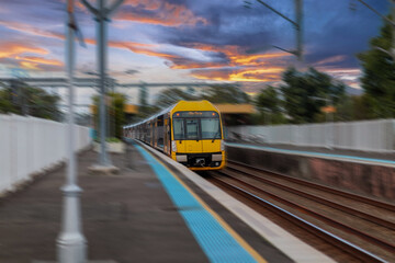 Obraz premium Passenger Train going through Lewisham Train Station at Sunset a suburban Sydney train Station in Sydney NSW Australia