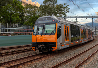 Obraz premium Passenger Train going through Lewisham Train Station at Sunset a suburban Sydney train Station in Sydney NSW Australia