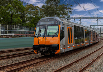 Obraz premium Passenger Train going through Lewisham Train Station at Sunset a suburban Sydney train Station in Sydney NSW Australia