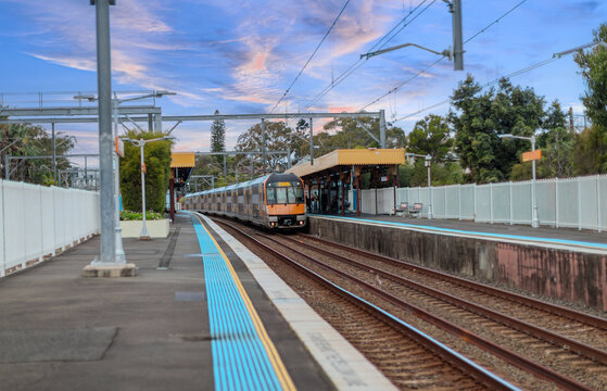 Passenger Train going through Lewisham Train Station at Sunset a suburban Sydney train Station in Sydney NSW Australia