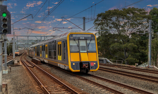 Passenger Train going through Lewisham Train Station at Sunset a suburban Sydney train Station in Sydney NSW Australia
