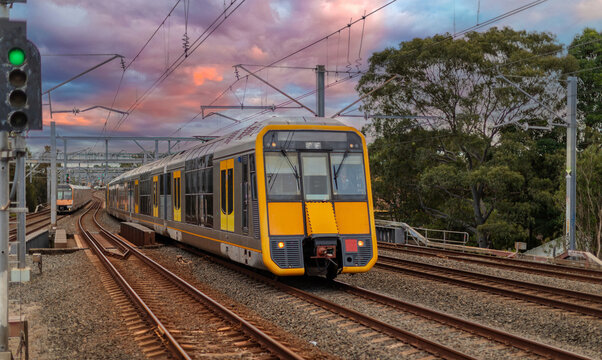 Passenger Train going through Lewisham Train Station at Sunset a suburban Sydney train Station in Sydney NSW Australia