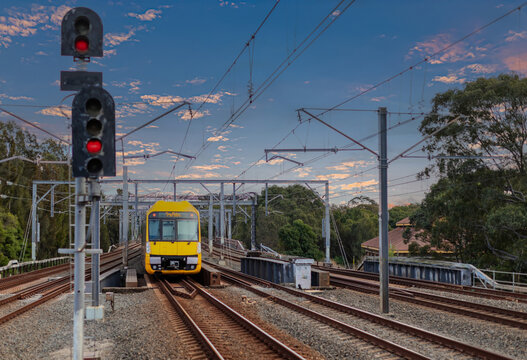 Passenger Train going through Lewisham Train Station at Sunset a suburban Sydney train Station in Sydney NSW Australia
