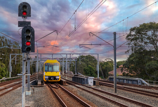 Passenger Train going through Lewisham Train Station at Sunset a suburban Sydney train Station in Sydney NSW Australia