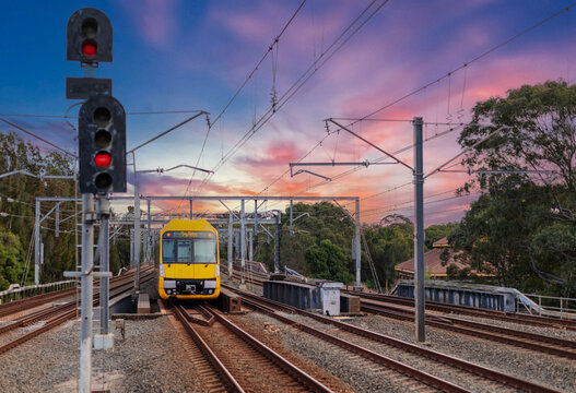 Passenger Train going through Lewisham Train Station at Sunset a suburban Sydney train Station in Sydney NSW Australia