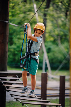 Kid climbing high ropes course adventure park