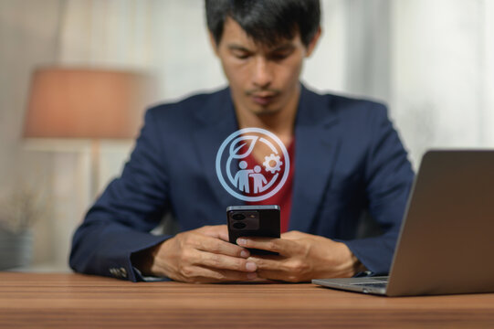 Businessman Using Smartphone with Digital Technology Icon and Laptop
