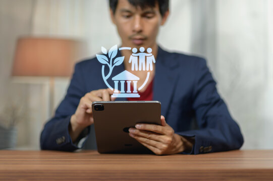 Businessman Using Tablet with Digital Overlay of Growth and Connection Icons in Office Environment