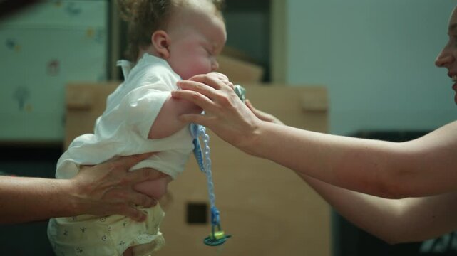 Therapist or parent holding an infant in a prone position, focusing on pediatric physical therapy and early childhood development