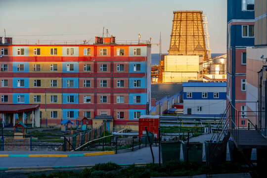 Soviet apartment building with factory cooling chimney at industrial area of Anadyr, Russia.

