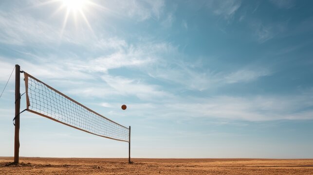Volleyball net and ball suspended over empty sandy plain