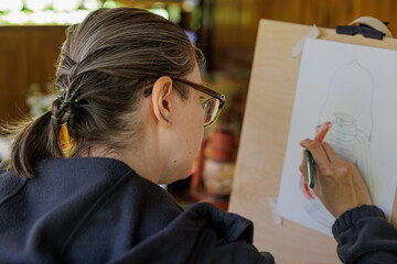 Creative spirit captures beauty in a cozy art studio during a sunny afternoon © AlexKriv