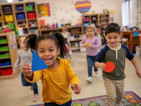 Diverse Group of Happy Preschool Children Running and Playing with Colorful Geometric Shapes in a Vibrant Classroom Setting