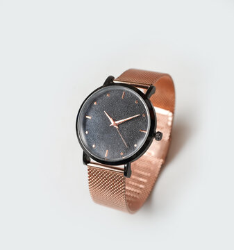Elegant Rose Gold Analog Watch with Mesh Band and Black Textured Face on White Background