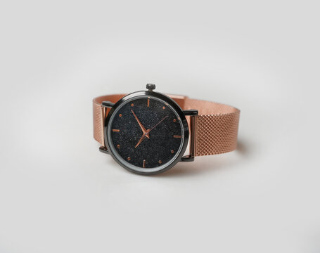 Elegant Rose Gold Analog Watch with Mesh Band and Black Textured Face on White Background