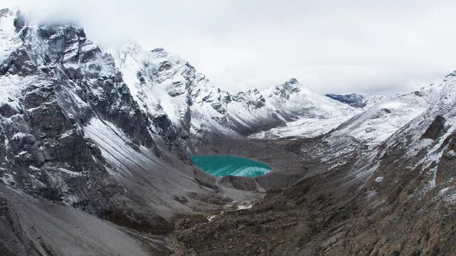 Drone view of beautiful snow covered mountains and peaceful lake, Ama Drime Snow Mountain and Dingjie Zongcuo Lake in Dingjie, Shigatse, Tibet, China. Travel concept 4k real time footage aerial view.