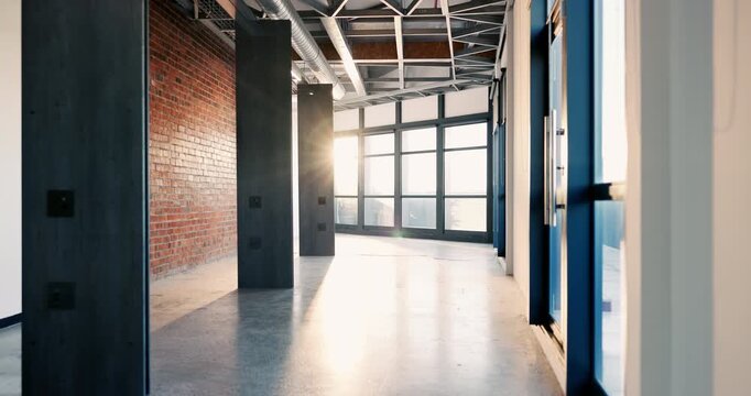 Workplace, building and windows with exterior design in hallway of industrial architecture. Empty, construction or structure with lens flare, interior, corridor for space or view in modern office