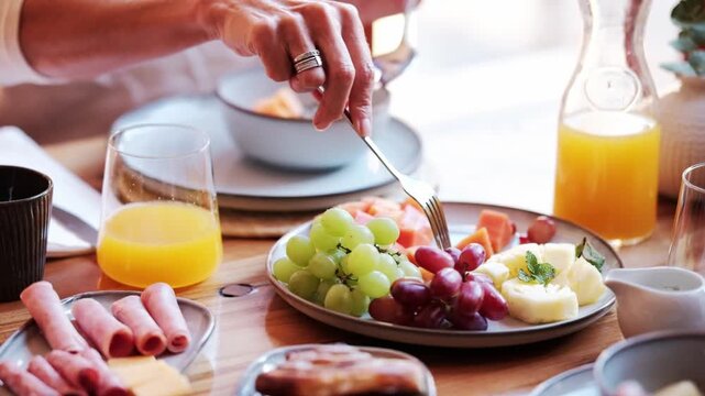 A couple share a fruit platter at the breakfast table