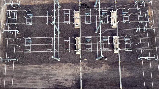 Aerial pullback and tilt reveal of a large electrical substation powering a hyperscale data center campus in Eagle Mountain, Utah.