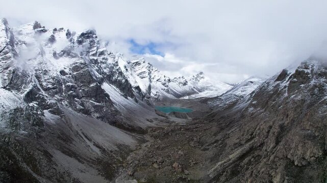 Drone view of beautiful snow covered mountains and peaceful lake, Ama Drime Snow Mountain and Dingjie Zongcuo Lake in Dingjie, Shigatse, Tibet, China. Travel concept 4k real time footage aerial view.
