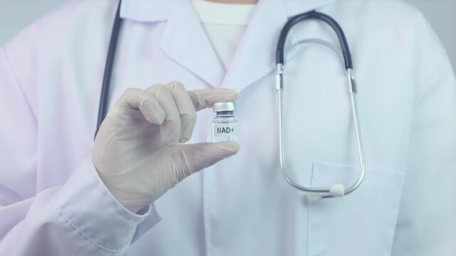 Confident professional doctor holding medical vial in hand offers advanced nad+ therapy clinical healthcare for wellness support