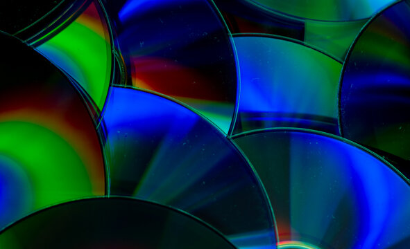 Reflection of the surface of a DVD discs with artistic lighting close-up