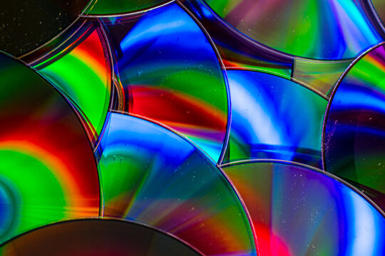 Reflection of the surface of a DVD discs with artistic lighting close-up