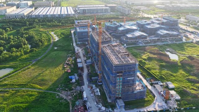 Aerial View of Building Construction Site with Tower Cranes and Scaffolding