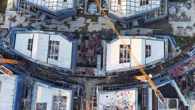Aerial View of Building Construction Site with Tower Cranes and Scaffolding