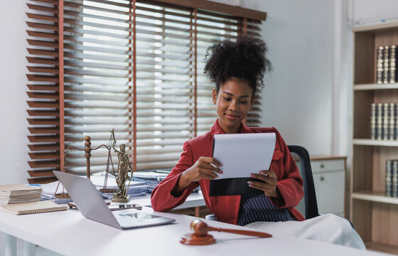 African american female lawyer reviewing legal documents in office