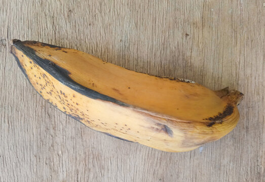 to bep view of a single boiled banana on a rustic wooden texture background