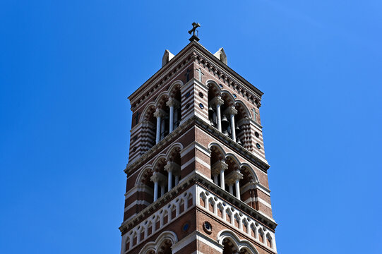 Church bell tower of St. Paul's Within the Walls. arched windows, stone columns. Gothic Revival style tower. the first Protestant church in Rome, Italy. blue sky. architecture and travel