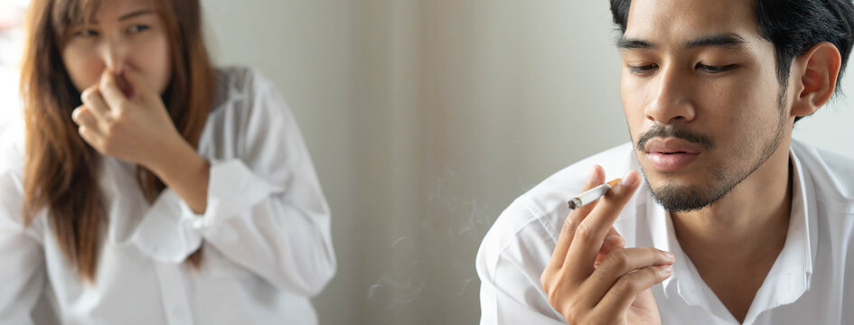 passive smoking effect, person cover his nose and avoid smoker near him