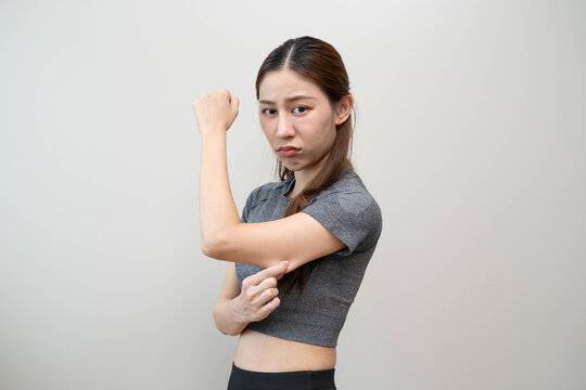Body care and weight loose concept, Close-up shot of woman looking at mirror grab her skin around under arm and worry about her figure.