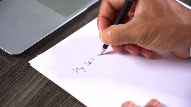 Close Up Shot of Hand Writing My Last Will on a Blank Paper